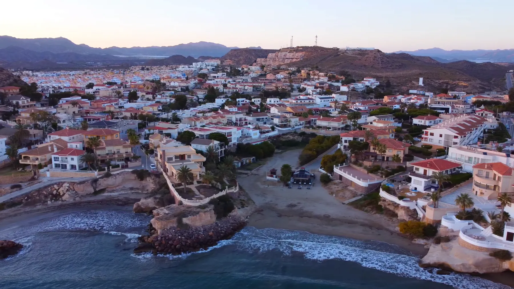 San Juan de los Terreros from the air at dusk, with Costa Tranquila cove