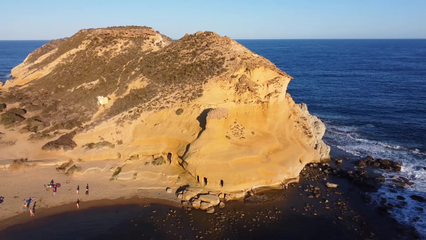 Formaciones de roca dorada junto al mar en Los Cocedores