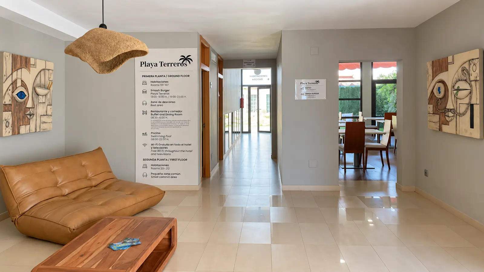 Hotel hall with a leather sofa, a fibre lamp and two pieces by Manuel Hervás